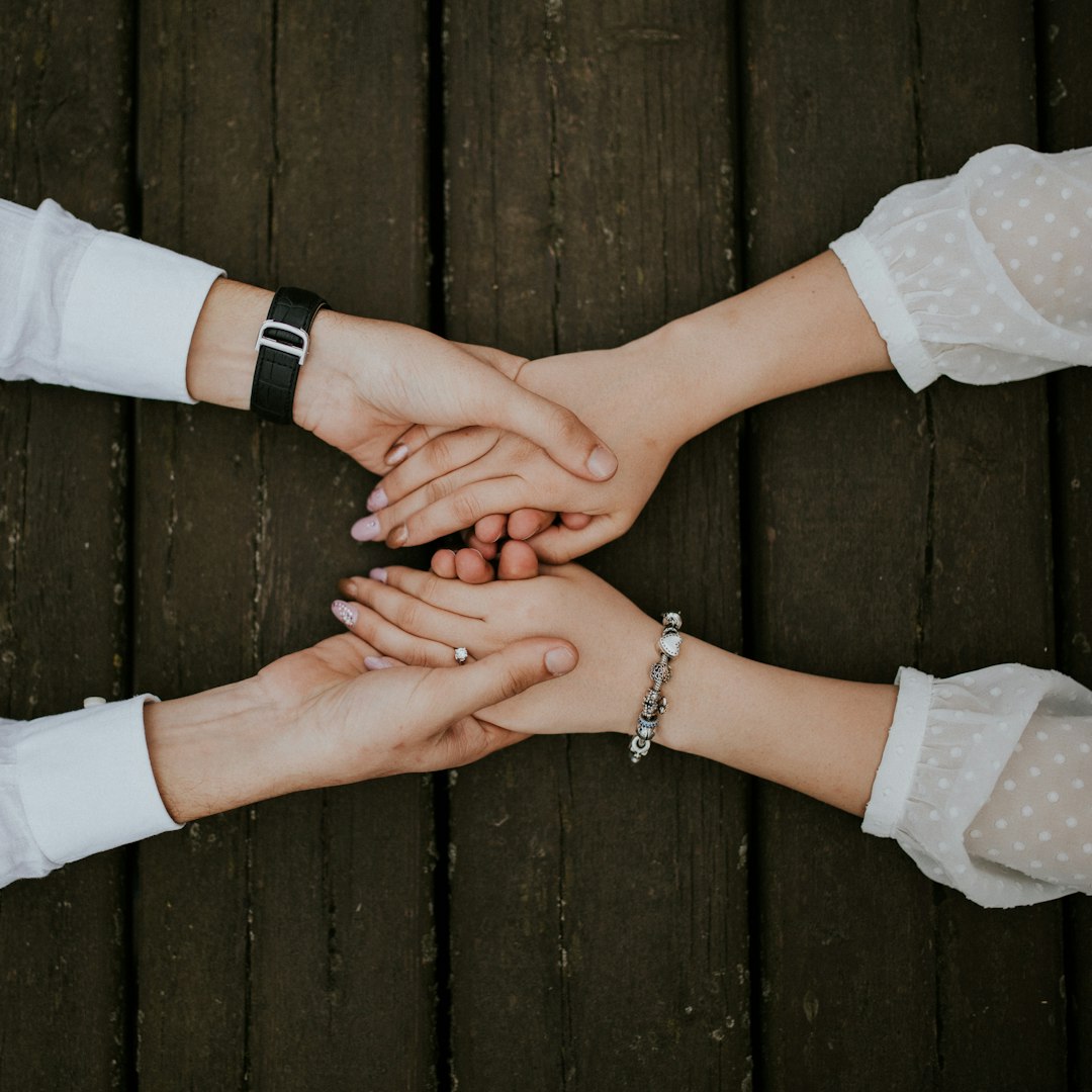Photo by Alvin Mahmudov flat lay photography of man and woman holding hands together